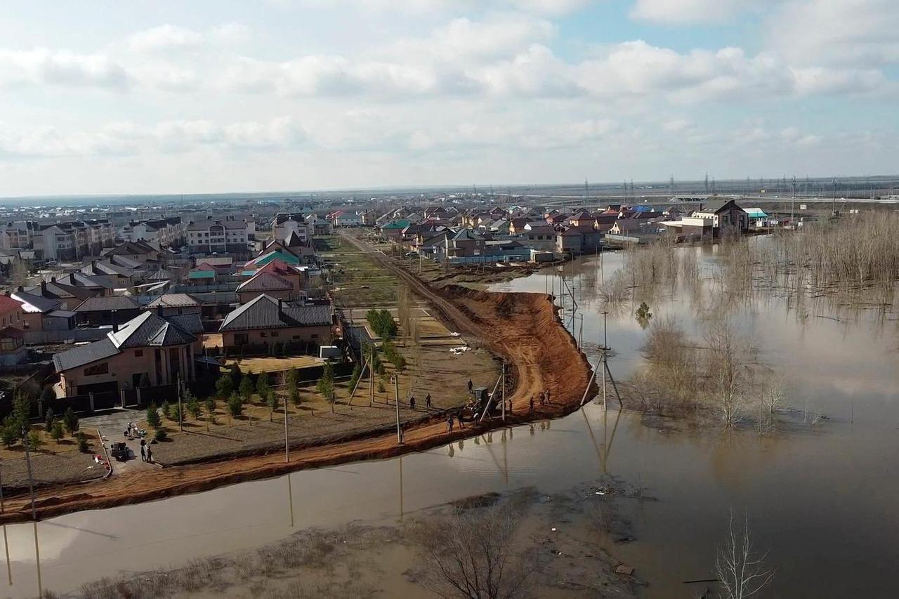 Russian villagers build homemade dam to keep out floods, in Orenburg region