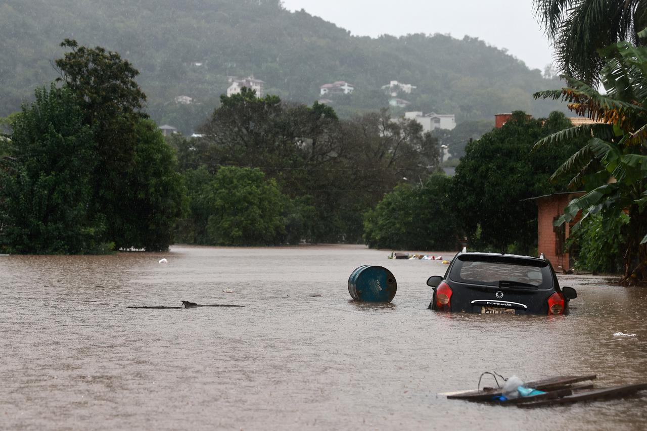 A car stands in the flooding water of the Taquari River during heavy rains in the city of Encantado in Rio Grande do Sul