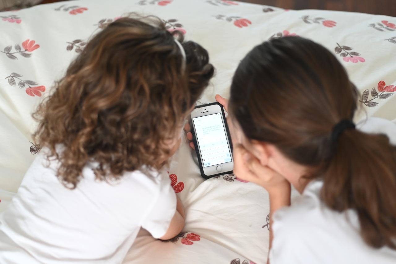 Young girls reading a text massage on a mobile phone